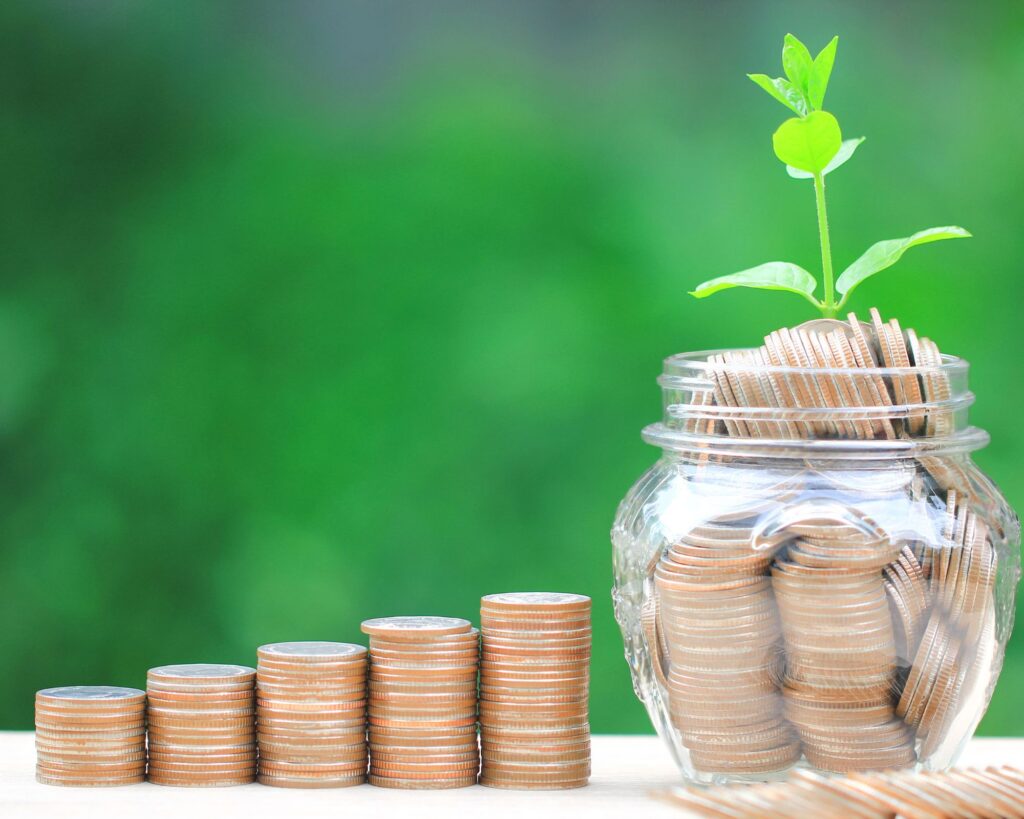 Stacks of coins and a jar of coins with a plant growing out of it. 14 Options for Business Capital Funding