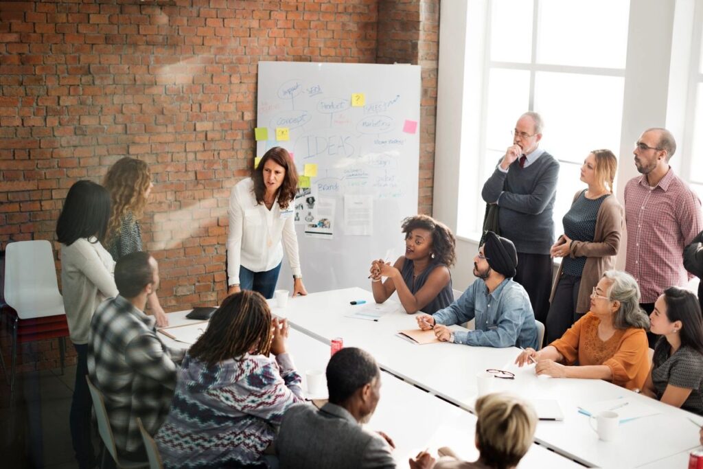 people sitting around a table taking a class for professional development for business owners