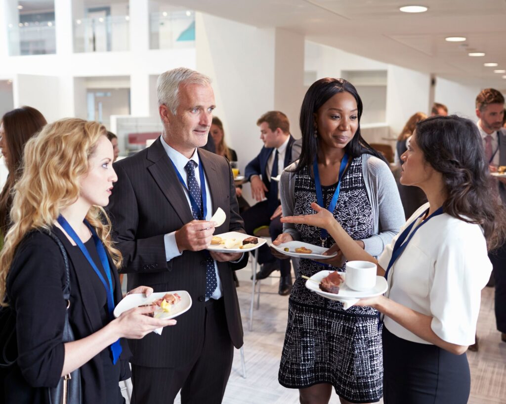 People networking at a group event. Strategies on how to get more customers to your business
